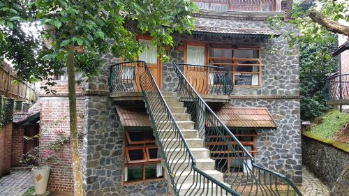 a stone building with a spiral staircase on it at Wildernest in Thekkady