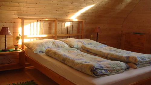 A bed or beds in a room at Drevenica Goralský Dvor