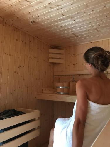 a woman is standing in a sauna at B&B Villa Anna, Venlo in Venlo