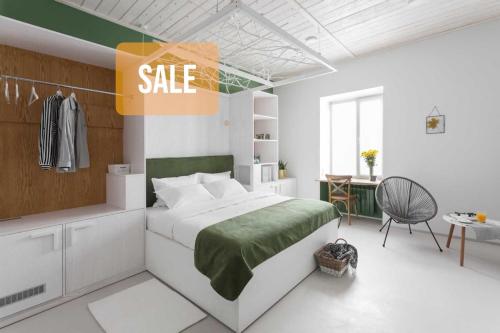 a bedroom with a bed with a sale sign on it at City Hotel Bortoli by Ribas in Odesa