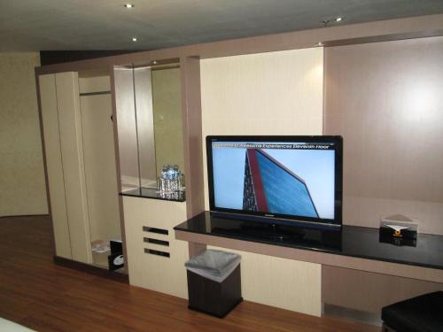 a flat screen tv sitting on a counter in a room at Aria Gajayana in Malang