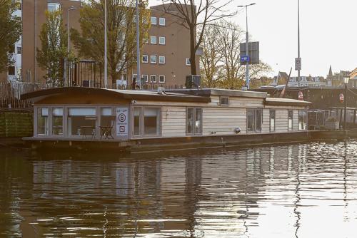 a small boat is docked in a body of water at Houseboat Little Amstel in Amsterdam