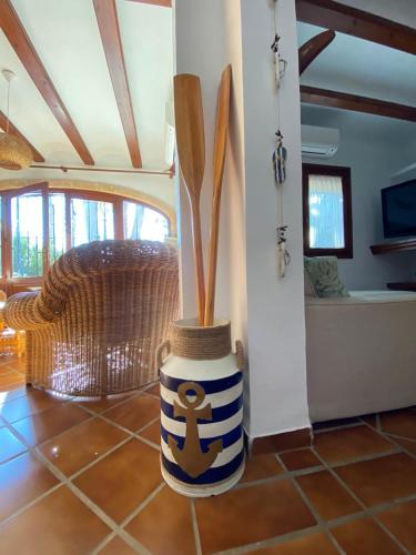 a blue and white vase with wooden utensils in a room at Royal Garden Santa Clara in Jávea