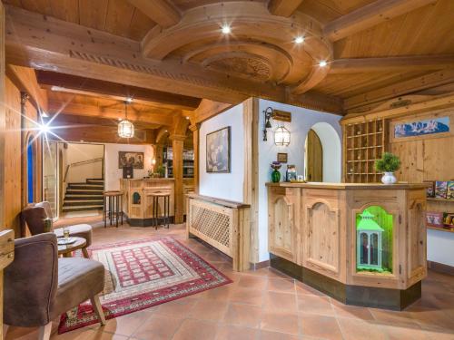 a large living room with wooden ceilings and a fireplace at Hotel Gasthof Felsenkeller in Kufstein