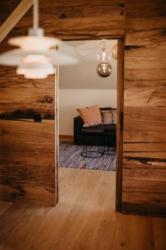a view of a living room with a couch through a doorway at Haus Wildmoos in Sankt Martin bei Lofer