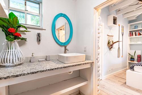 a bathroom with a sink and a mirror at Butterfly Cottage at Viking Hill - Love Beach in Nassau