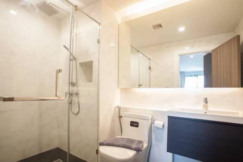a bathroom with a toilet and a shower and a sink at De Amber Bang Sarae by FunnyProperty in Bang Sare