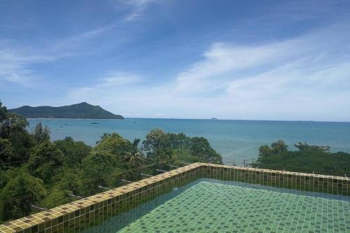 a swimming pool with a view of the ocean at De Amber Bang Sarae by FunnyProperty in Bang Sare