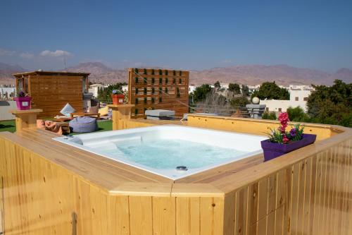 a hot tub on top of a wooden deck at Swiss Royal DAHAB in Dahab