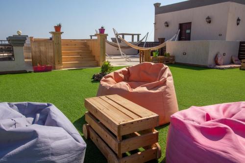 a backyard with two bean bags and a hammock at Swiss Royal DAHAB in Dahab