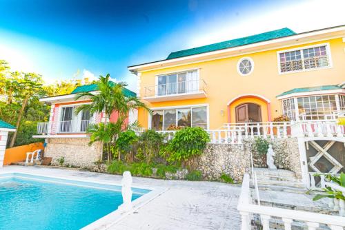 a house with a swimming pool in front of it at Studio Candy at Viking Hill - Love Beach in Nassau