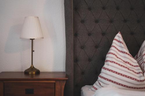a bedroom with a bed with a lamp and a pillow at Gabis kleine Spezerey in Gries am Brenner