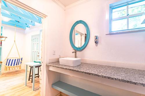 a bathroom with a sink and a mirror at Studio Candy at Viking Hill - Love Beach in Nassau