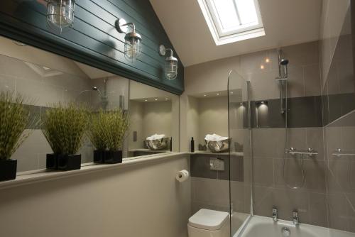 a bathroom with a toilet and a glass shower at Stownes in Stow on the Wold