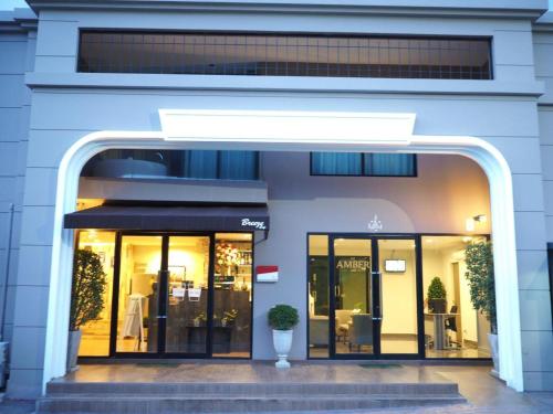 a store front of a building with glass doors at De Amber Bang Sarae by FunnyProperty in Bang Sare