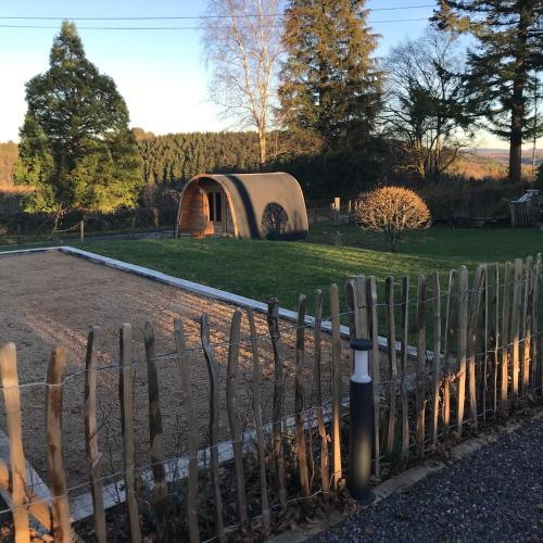 a fence in front of a field with a yurt at Villa Charles in Francorchamps