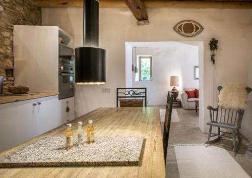 a kitchen with a wooden table with bottles on it at Casa Mia in Fasoula
