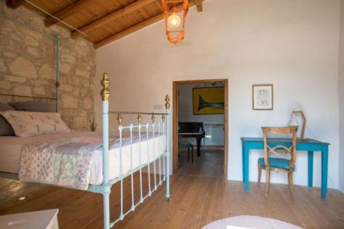 a bedroom with a bed and a table and a desk at Casa Mia in Fasoula