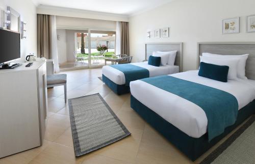 Ein Bett oder Betten in einem Zimmer der Unterkunft JAZ Soma Beach