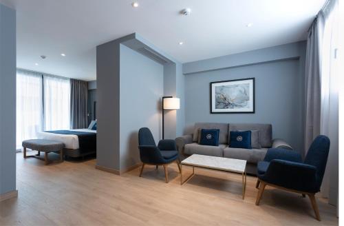a living room with a couch and a bed at Hotel Lima - Adults Recommended in Marbella
