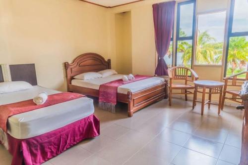 Tempat tidur dalam kamar di Nipah River View Bajet Hotel