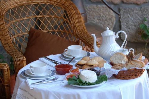 a table with a plate of bread and a basket of food at Agro-Turismo - Quinta do Pinheiro in Cavadoude