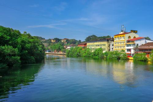 a river with buildings on the side of it at Hotel Sona in Panaji