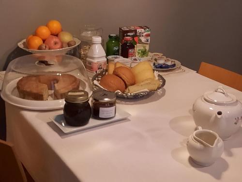 a table with a plate of bread and fruit on it at r&b del vicolo in Cesena