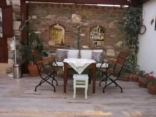 a table and chairs on a patio at Hotel Mary's House in Selcuk