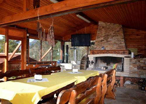 代溫的住宿－Къщи за гости "КАРАТА" 2，一间带桌子和壁炉的用餐室