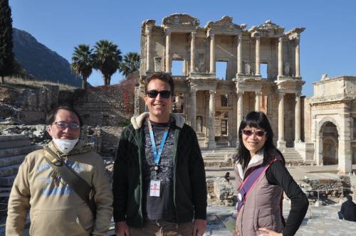 three people standing in front of the ruins at Hotel Mary's House in Selcuk