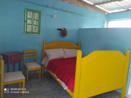 a bedroom with a bed and a table and a chair at Los Versos de Zaira in San Onofre