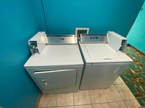 two machines in a room with a blue wall at Tropicana Inn and Suites in Dallas