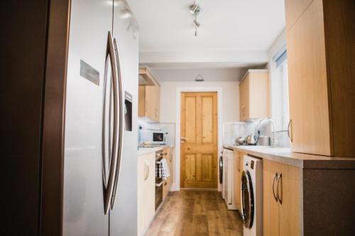 a kitchen with white appliances and a refrigerator at Unique and Stylish close to Beaches Restaurants Shops in Cleethorpes