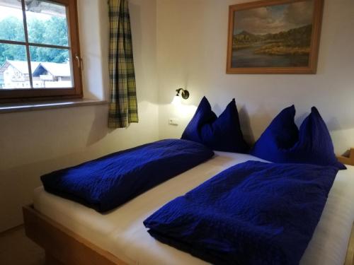 a bedroom with two blue pillows on a bed at Scheffauerhof in Scheffau am Wilden Kaiser