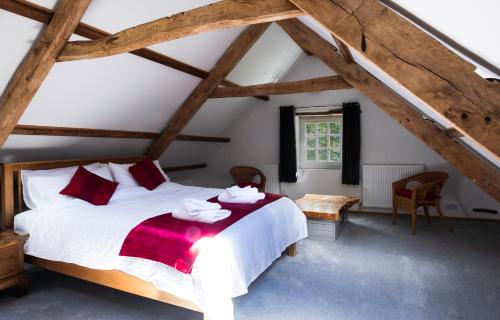 a bedroom with a bed with towels on it at Jopes Mill and Lodge in Looe