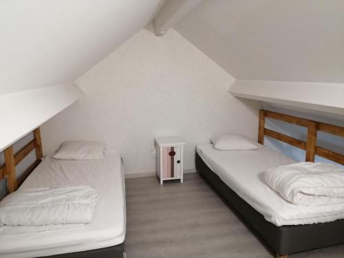 a room with two beds and a small table at Durbuy, ses ruelles pittoresques et sa gastronomie in Durbuy