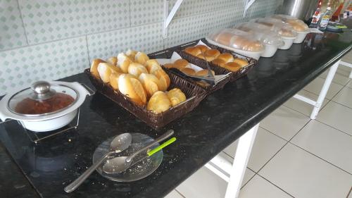 two baskets of bread and other food on a table at Yves Hotel in Porto Velho