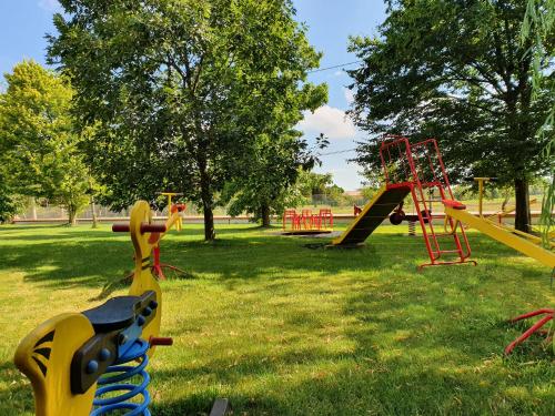 a park with playground equipment in the grass at Agriturismo il Cascinale in Treviso