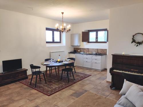a living room with a table and chairs and a piano at Casa Martin , 4 bedroom villa in Bisenti