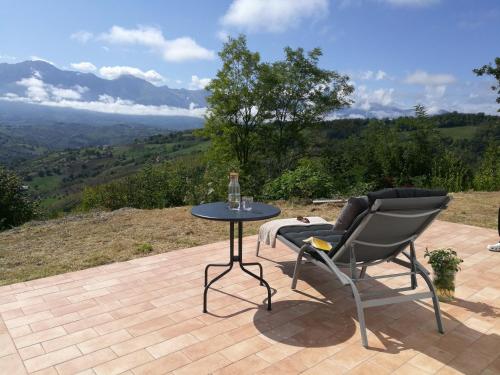 a table and chairs on a patio with a view at Casa Martin , 4 bedroom villa in Bisenti