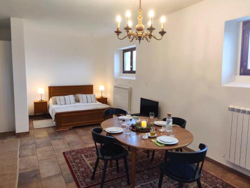 a dining room with a table and chairs and a bed at Casa Martin , 4 bedroom villa in Bisenti