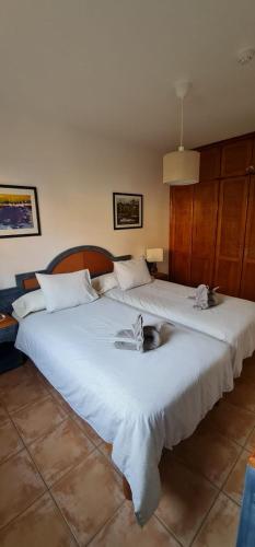 two large white beds in a room at Holiday in Playa Calera - Swimming pool in Valle Gran Rey
