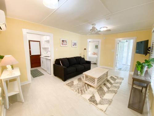 a living room with a black couch and a table at Authors Key West Guesthouse in Key West