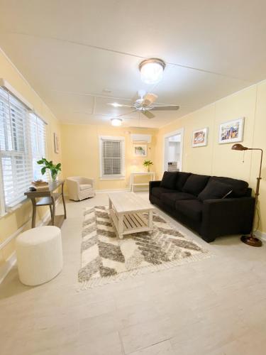 a living room with a black couch and a table at Authors Key West Guesthouse in Key West