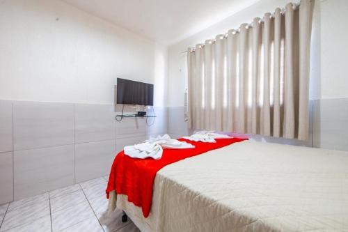 a bedroom with a large bed and a shower at Luxury Flats Ambiente Cristão in Fortaleza