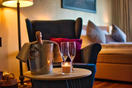 a table with a bucket and glasses and a candle at Altstadtapartment Mainz in Mainz