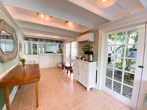 a large kitchen with a table and a large window at Authors Key West Guesthouse in Key West