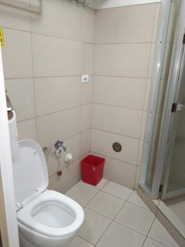 a bathroom with a white toilet and a shower at Wind and Sea at Wind Residences in Tagaytay