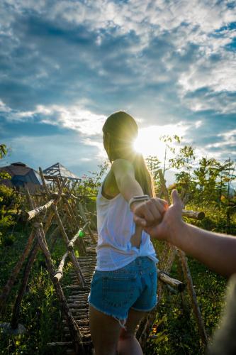 a woman is holding the hand of a man at Nacimiento Glamping in San Agustín
